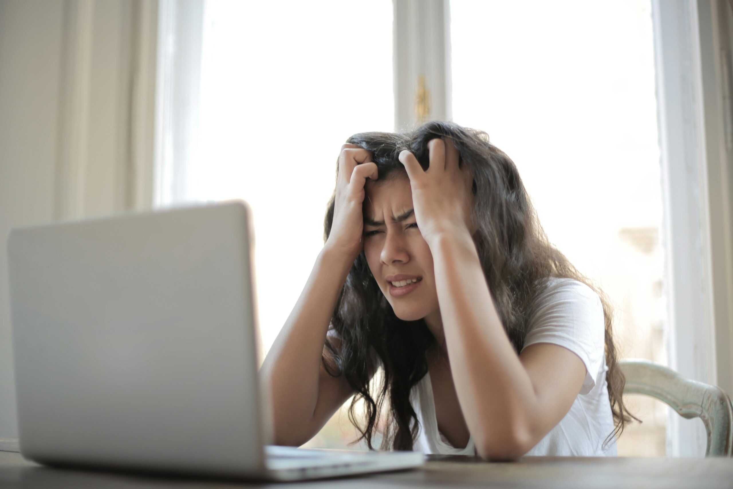 Employee looking stressed and exhausted at work due to burnout